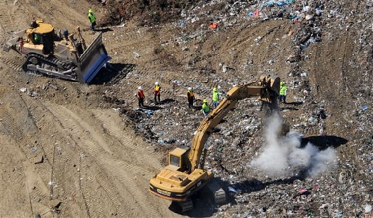 Search teams from examine a section of the Keller Canyon Landfill in Bay Point, Calif. on Friday. Police believe Frederick Sales, 35, who has been missing for more than a week, may have been killed by Efren Valdemoro, who is also a suspect in the death of Sales' father.